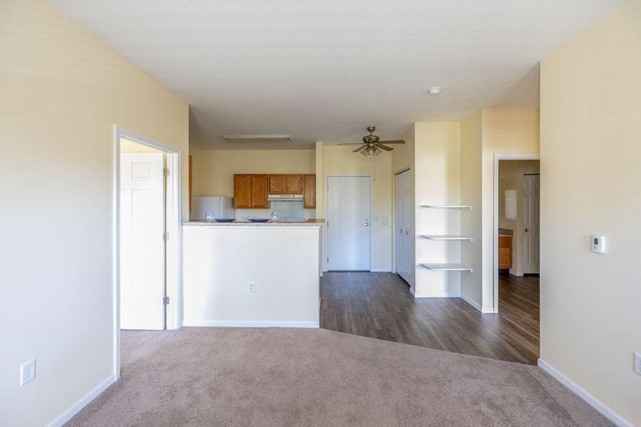 A kitchen with white appliances and wooden cabinets.
