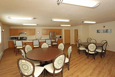 a dining room with a table and chairs and a kitchen