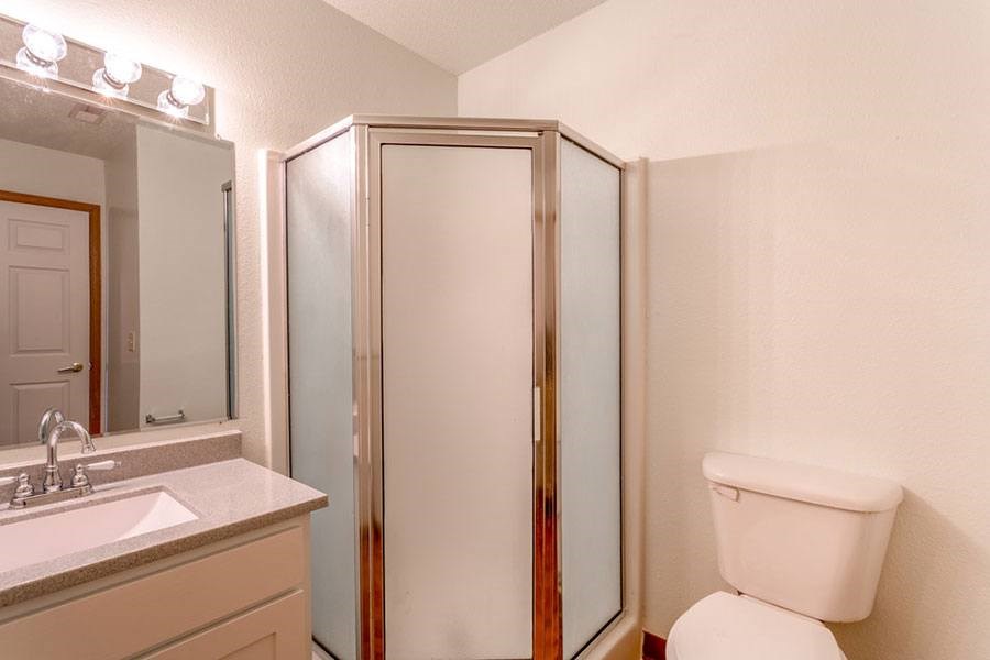 A white toilet sits next to a sink in a bathroom.