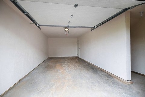 A room with a concrete floor and white walls.