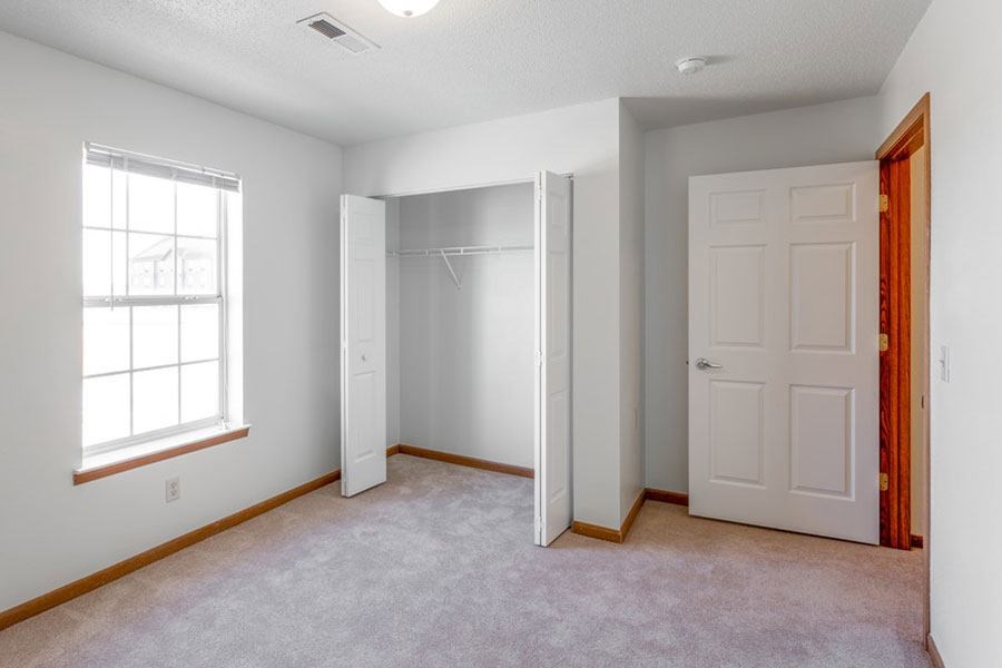 A room with a white door and a window.