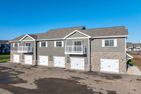 A two-story house with a garage on the side.