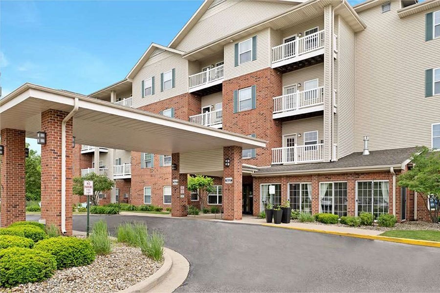 A large apartment complex with a covered walkway entrance.