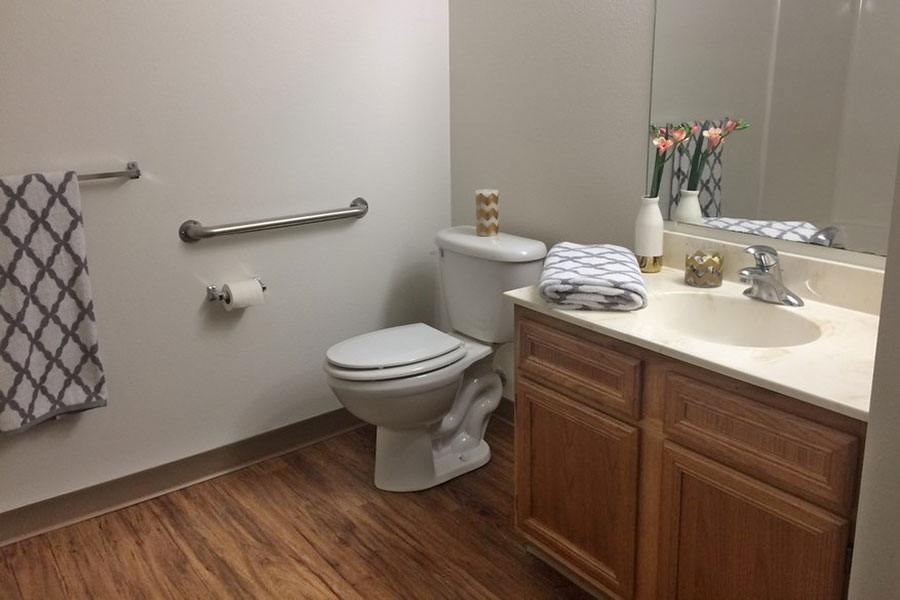 A white toilet sits next to a sink in a bathroom.
