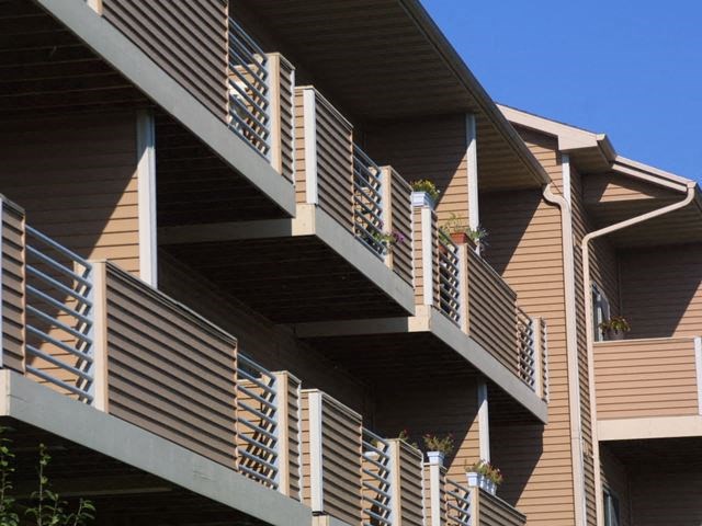a building with a balcony and a blue sky