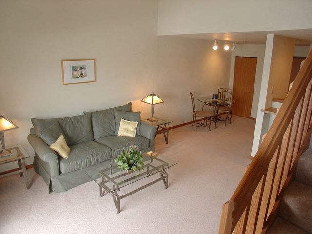 a living room with a couch and a glass table