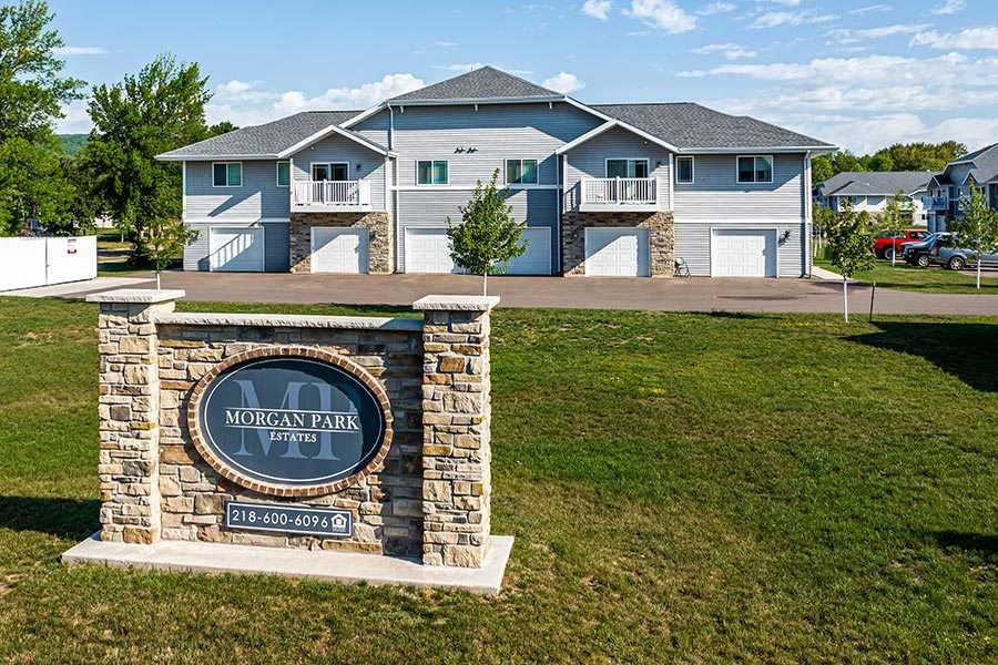 A sign for Morgan Park Estates in front of a house.
