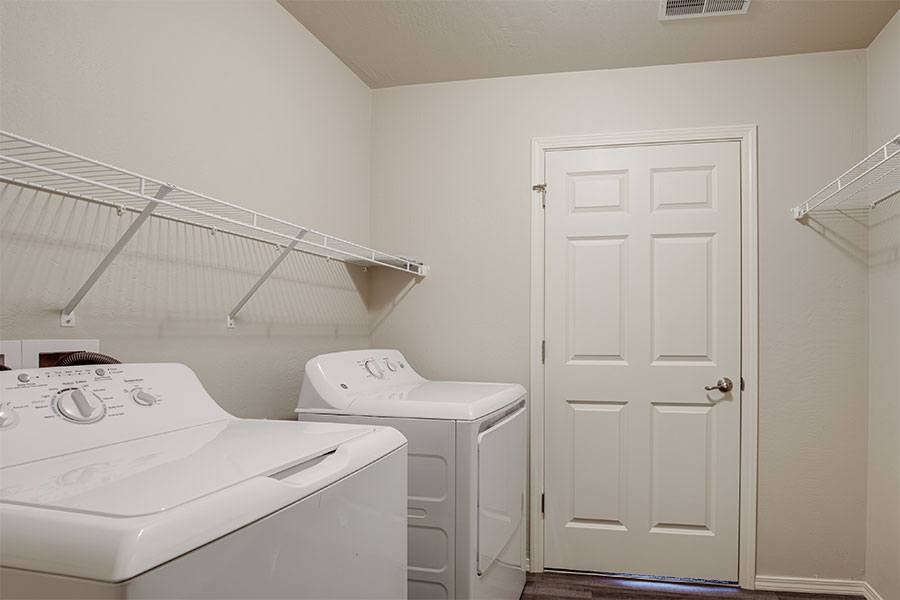 A white washer and dryer in a small laundry room.