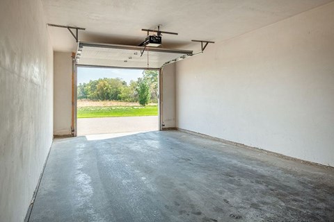 A room with a concrete floor and a ceiling fan.