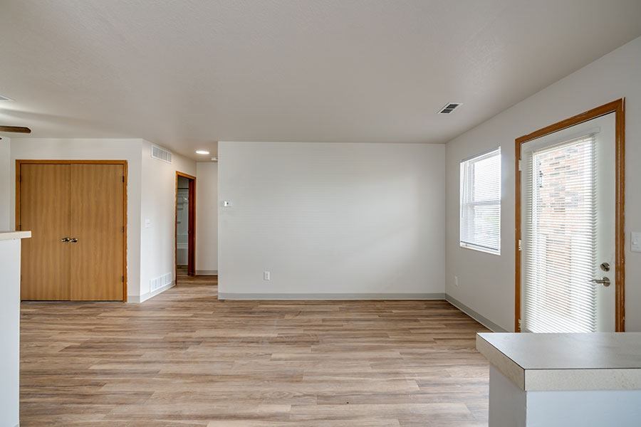 A room with a wooden floor and white walls.