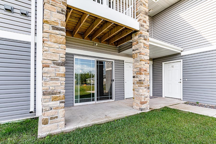 A house with a stone pillar and a white door.