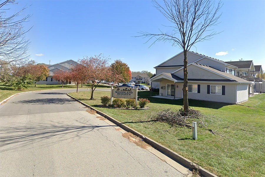 A residential street with houses and trees.