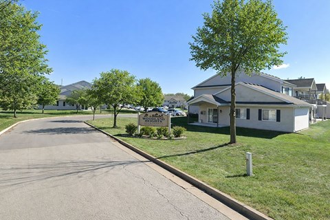 A residential street with houses and trees.