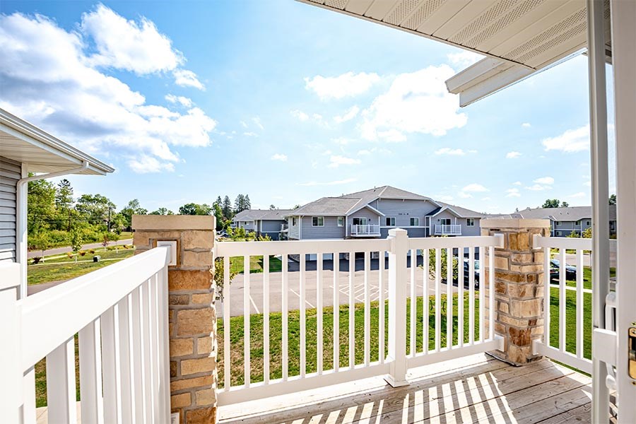 A white fence and a house in the background.