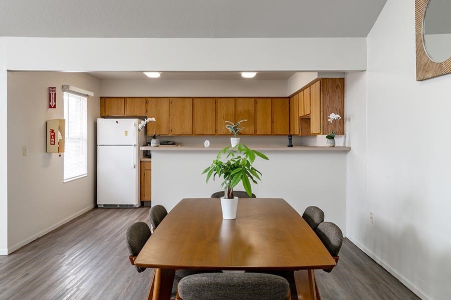 A dining room with a wooden table and chairs.