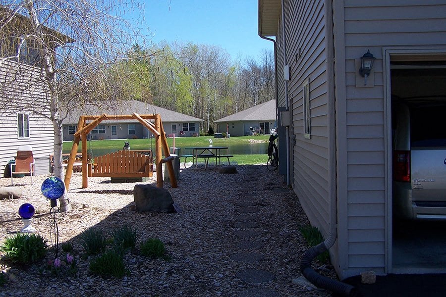 a backyard with a swing set and a playground