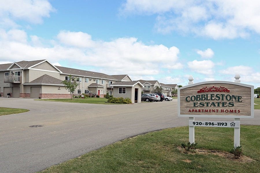 a sign in front of a row of houses