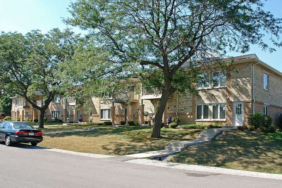 a car parked in front of a row of houses