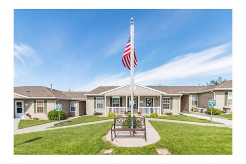a flag pole with an flag in front of a house
