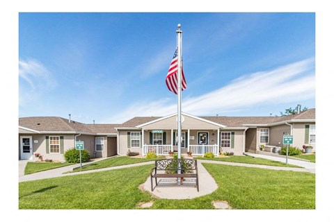 a flag pole with an flag in front of a house