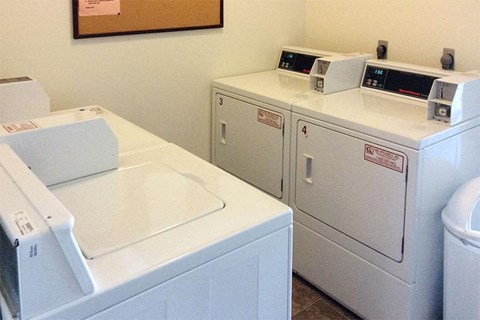 three washing machines are lined up next to each other