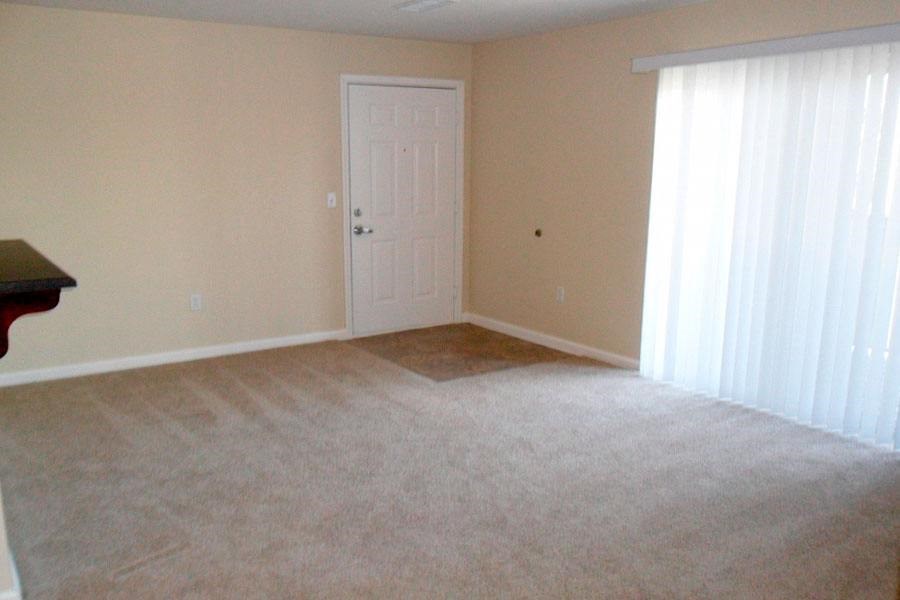 an empty room with a door and a window