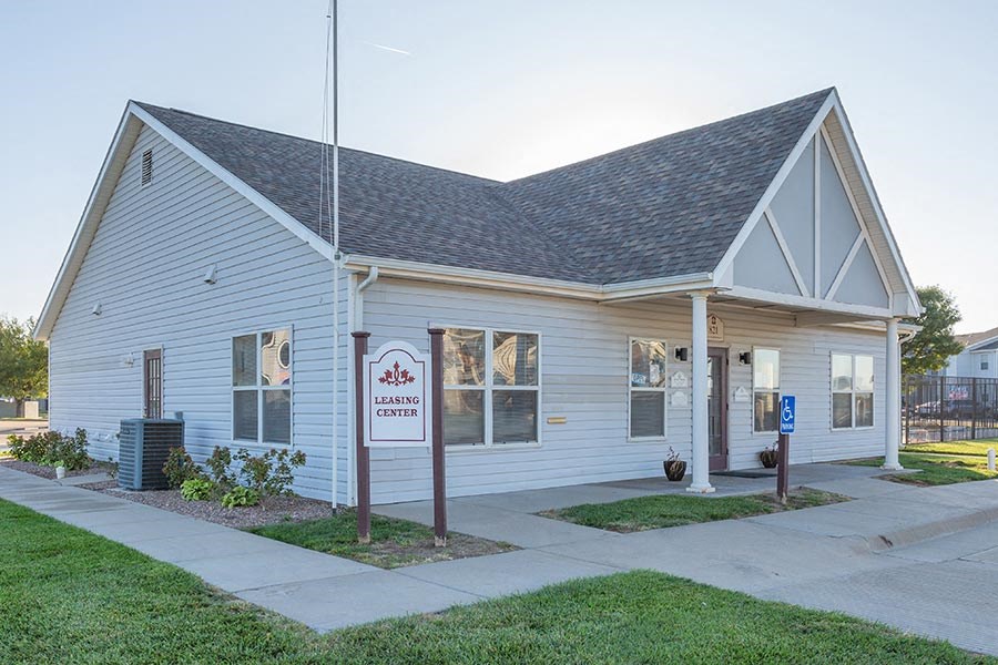 a white church building with a sidewalk in front of it