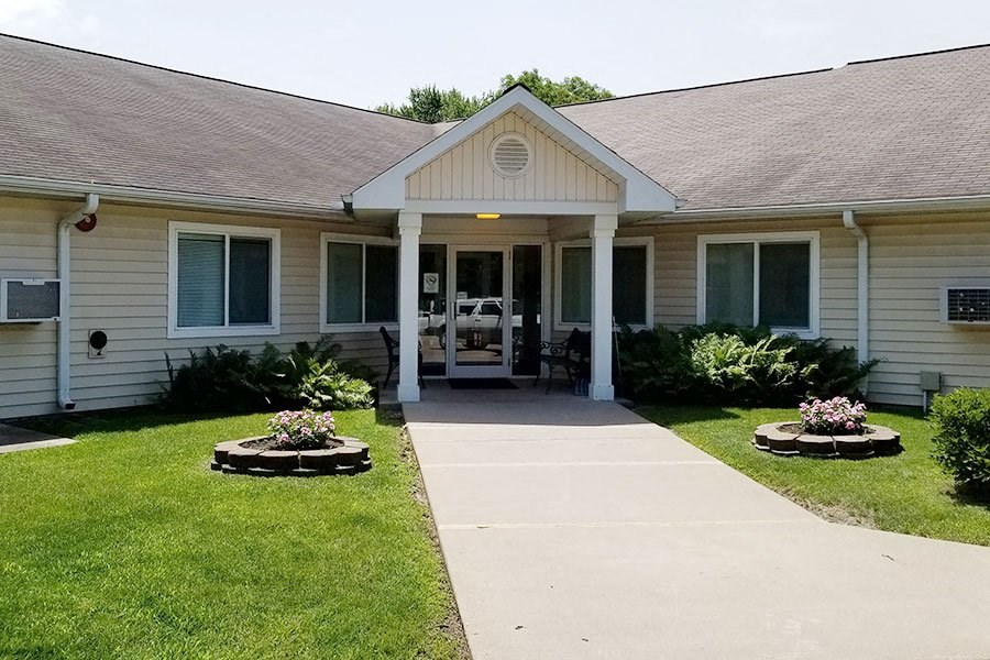 a white house with a sidewalk in front of it