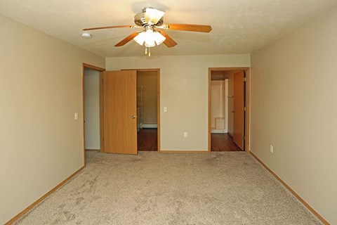 a empty living room with a ceiling fan