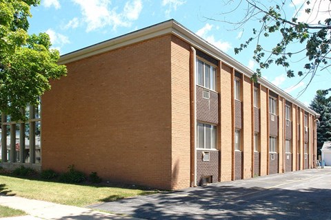 a brick building with a sidewalk in front of it