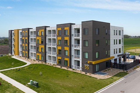 Apartment complex with the number 55 on the front.