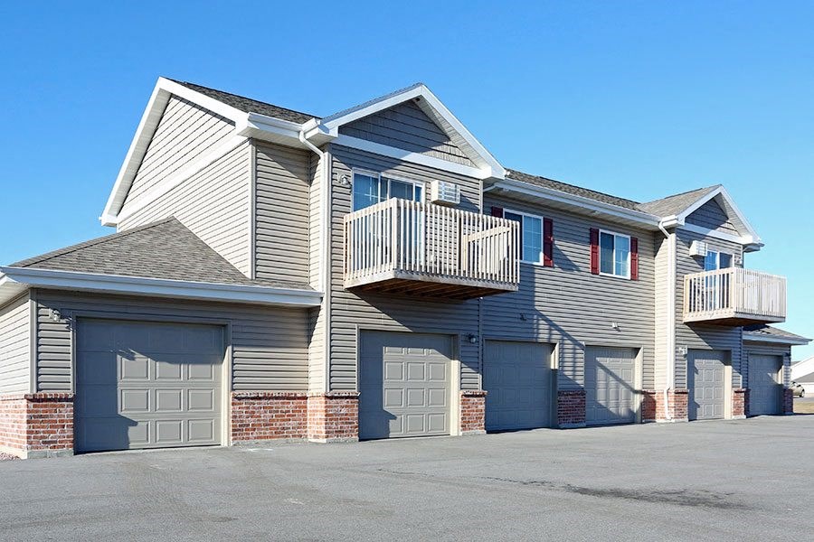 a house with a balcony and garages