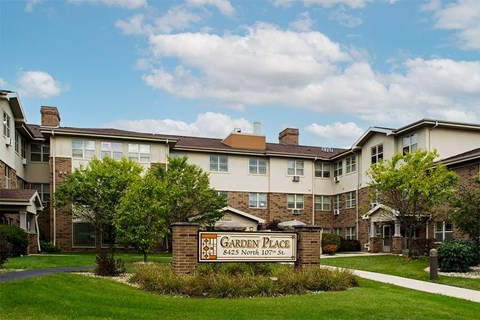 A sign in front of a building that says Garden Place.
