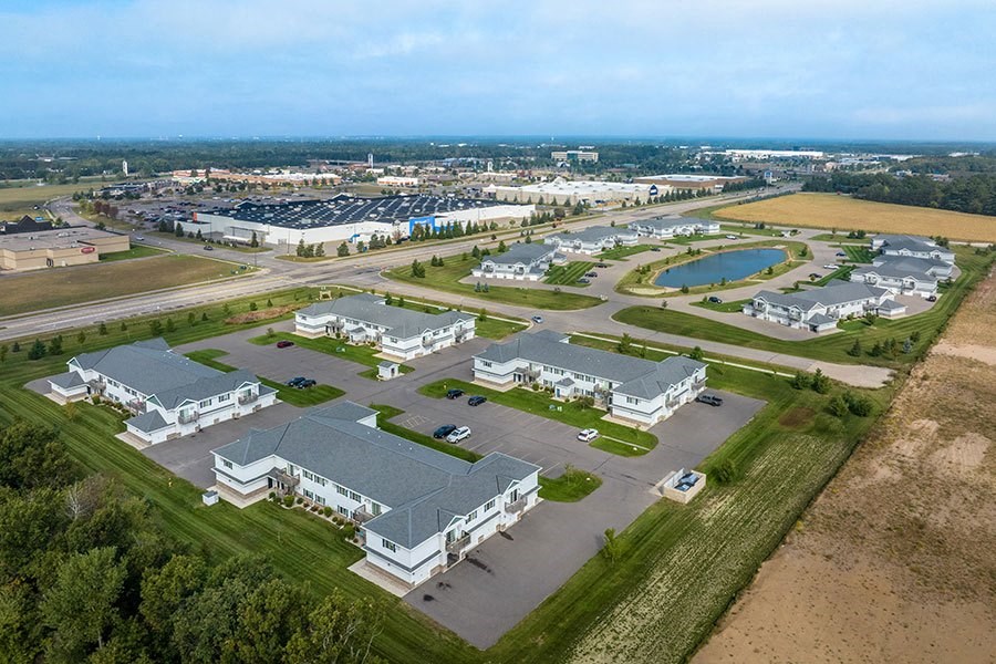 an aerial view of a parking lot and buildings