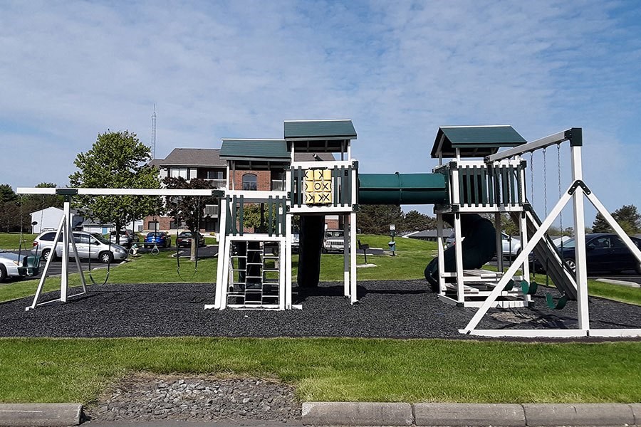 a playground with two sets of play equipment
