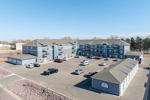A parking lot with cars and a building with a sign that says "Bakery".