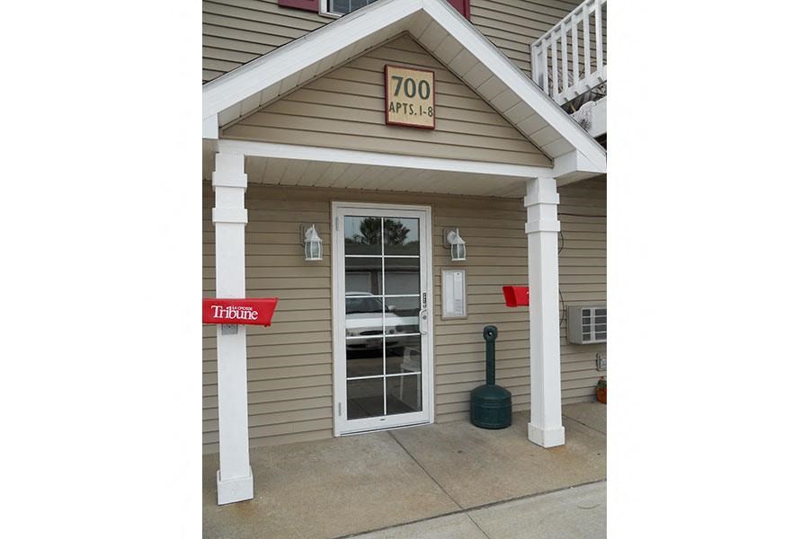 the front of a building with a door and a sign that says too time