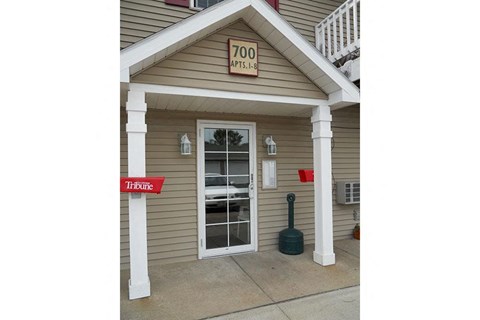 the front of a building with a door and a sign that says too time
