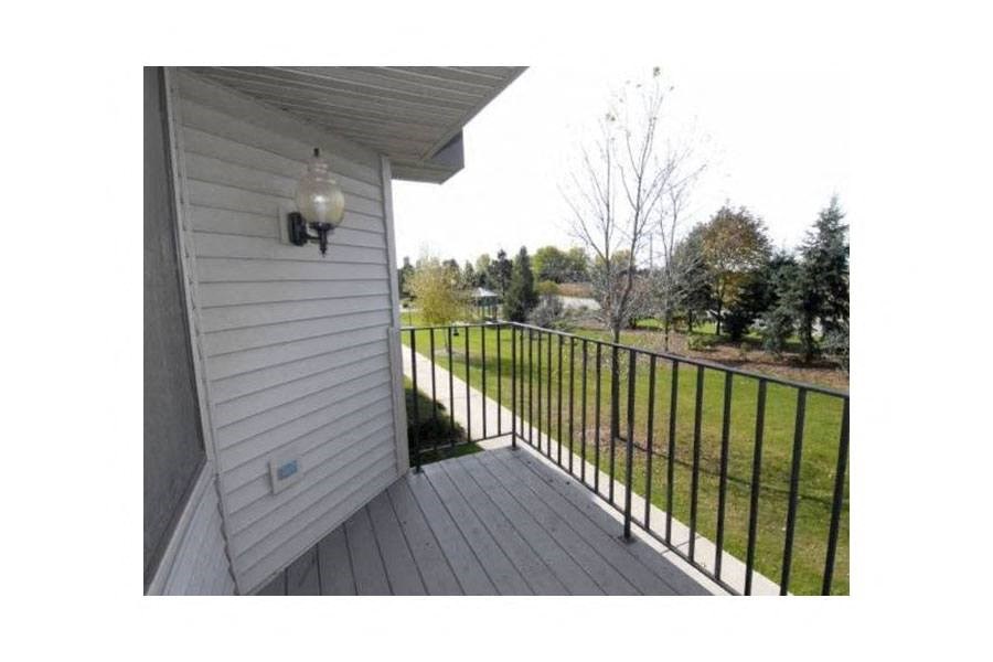 a view of a yard from a balcony of a house