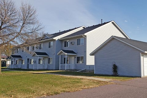 a blue and white house on the side of a street