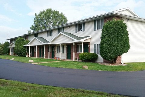 a white house with a street in front of it