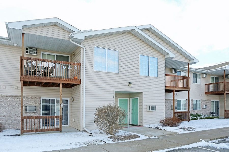 a white house with a green door
