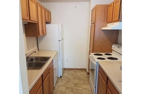 a kitchen with a stove and a refrigerator