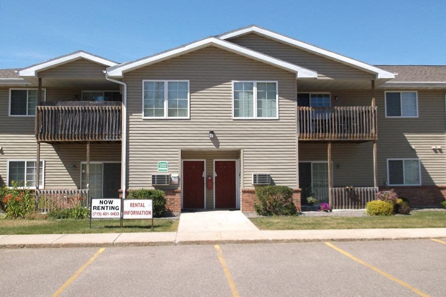 a tan house with a red door