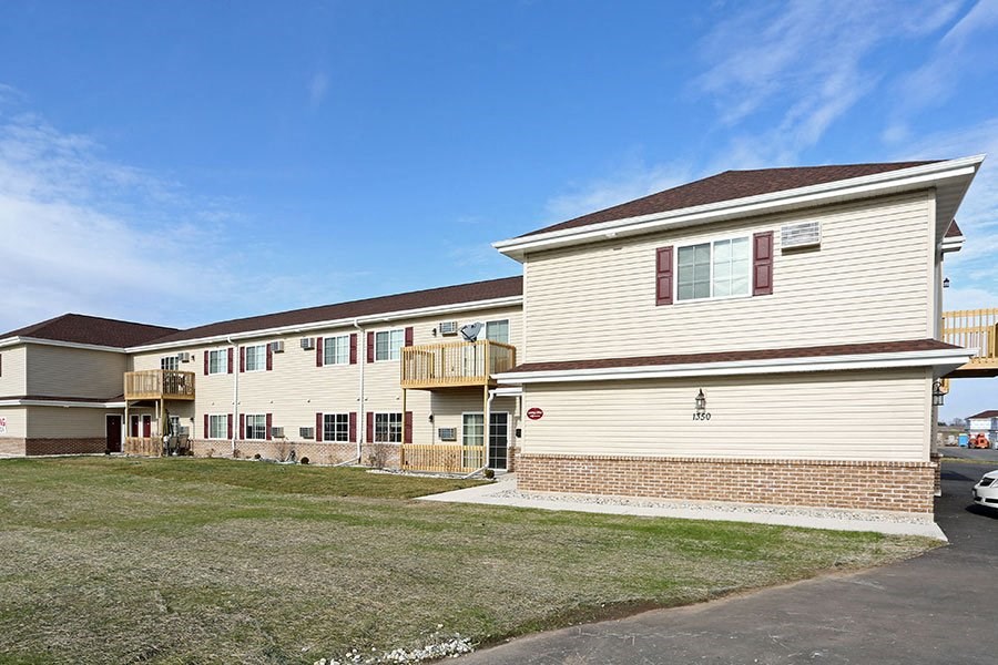a house with a yard and a car parked in front of it
