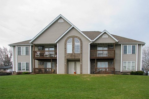 a house with a green lawn in front of it