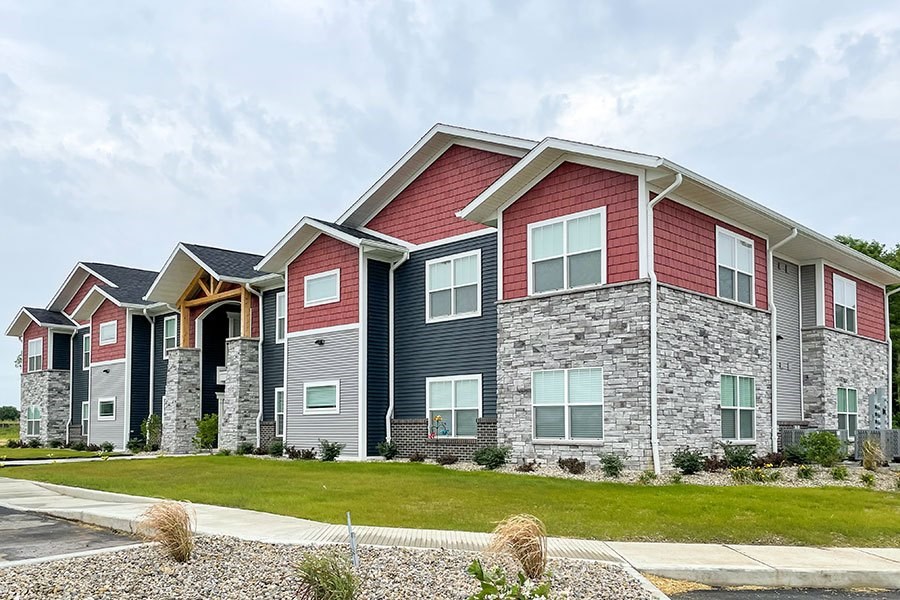 A modern two-story house with a red and grey exterior.