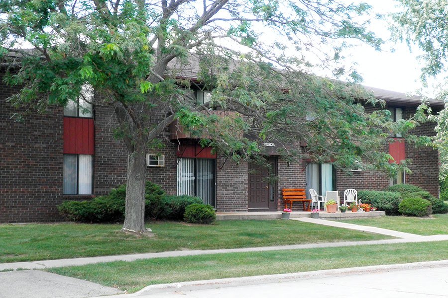 a brick house with a tree in front of it