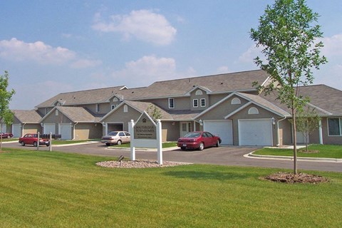 a large building with cars parked in front of it