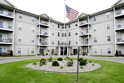 an flag flying in front of an apartment building